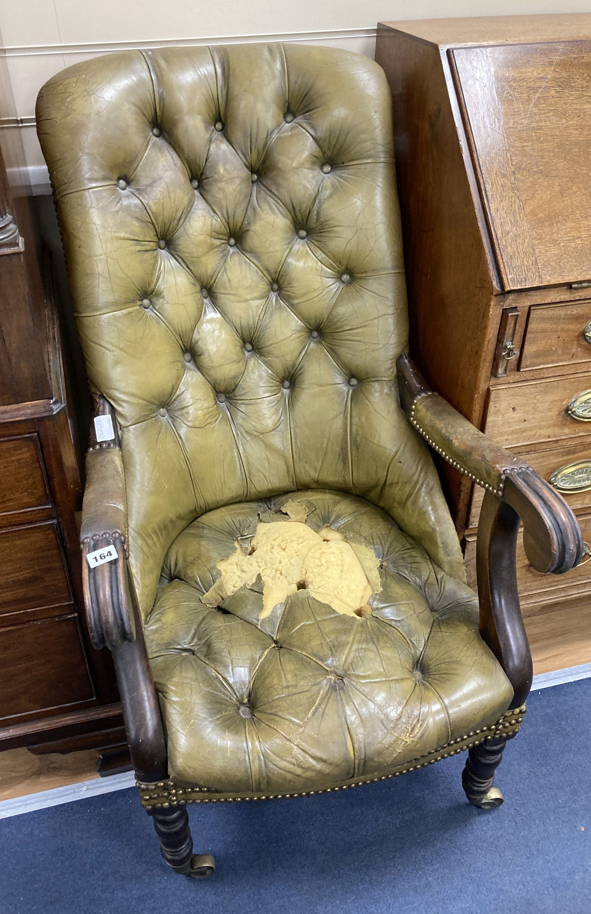 An early Victorian mahogany library armchair, upholstered in pale green leather, width 59cm, depth 84cm, height 104cm